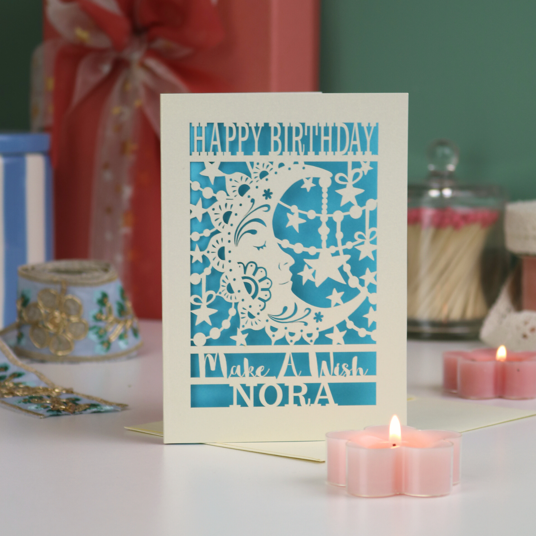 A laser cut birthday card with moon design and the text "Make a wish", personalised with a name
