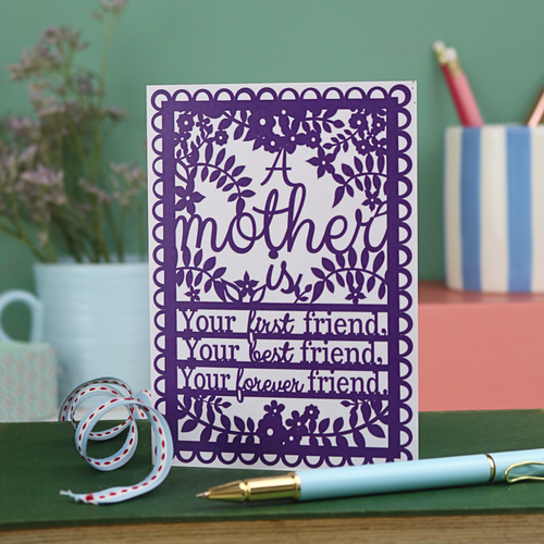 A printed card with purple design and text "A mother is your first friend, your best friend, your forever friend"