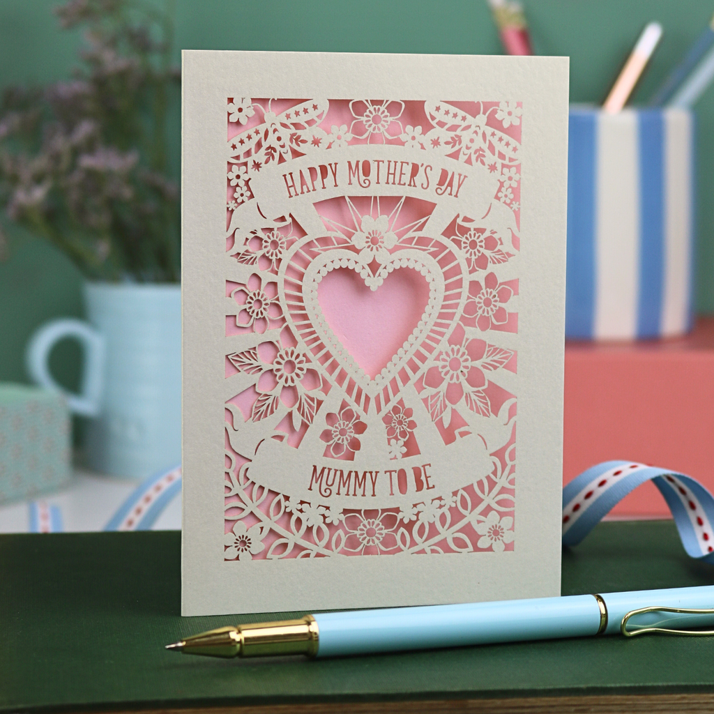 A laser cut Mother's Day card for a Mummy to be, with intricate heart and flower design and text "Happy Mother's Day, Mummy to be"