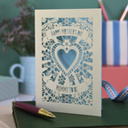 A laser cut Mother's Day card for a Mummy to be, with intricate heart and flower design and text "Happy Mother's Day, Mummy to be"