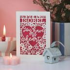 Laser cut Valentine's Card with 'ISOBEL You have my heart' text on a decorative surface with candles and flowers.