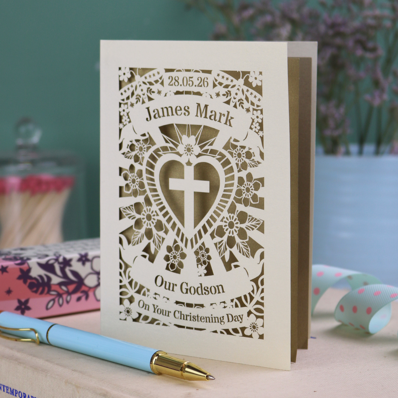Personalised Godson Christening card with decorative elements on a wooden surface.