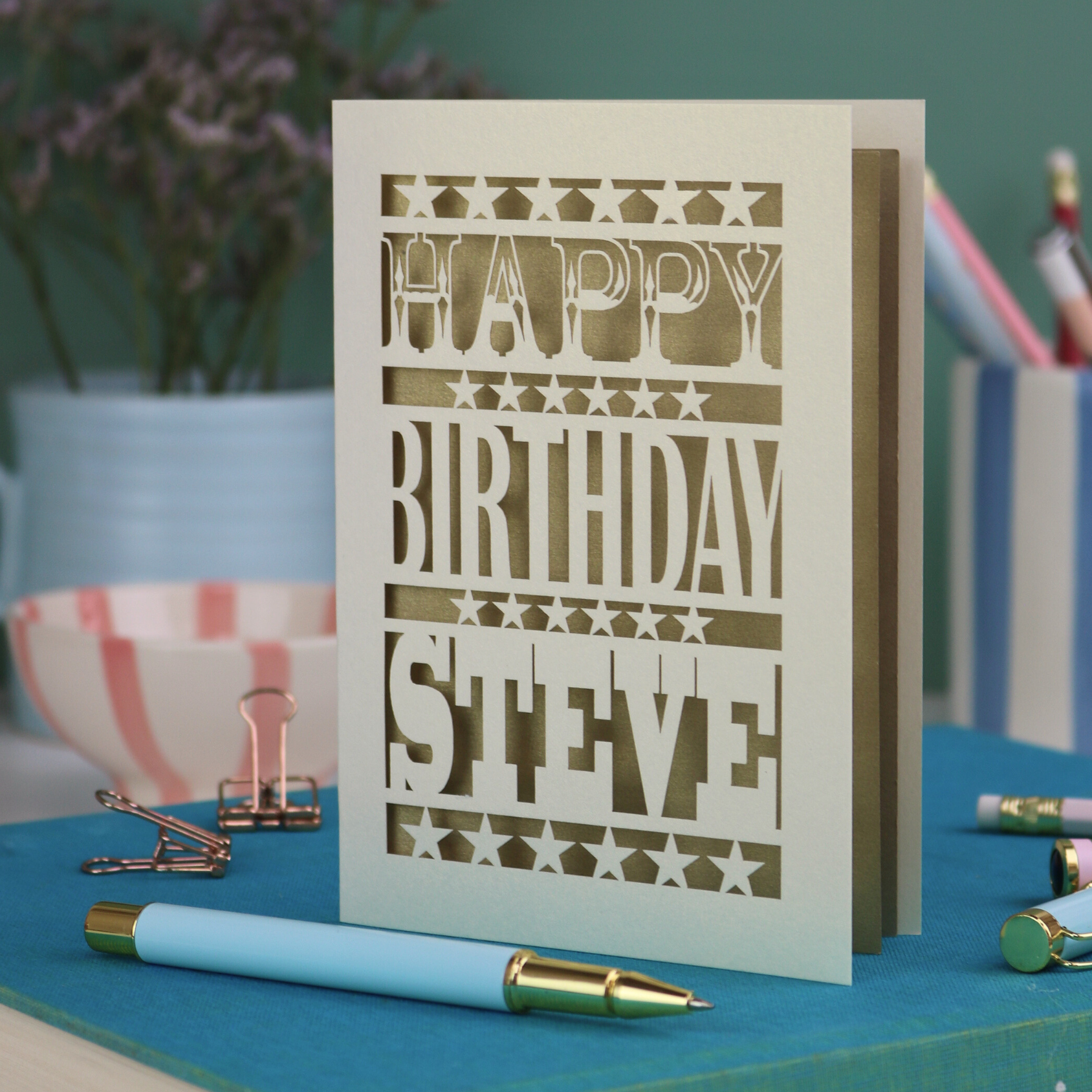 A laser cut personalised birthday card that says "Happy Birthday Steve" in bold text with star design.