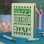 A laser cut personalised birthday card that says "Happy Birthday Steve" in bold text with star design.