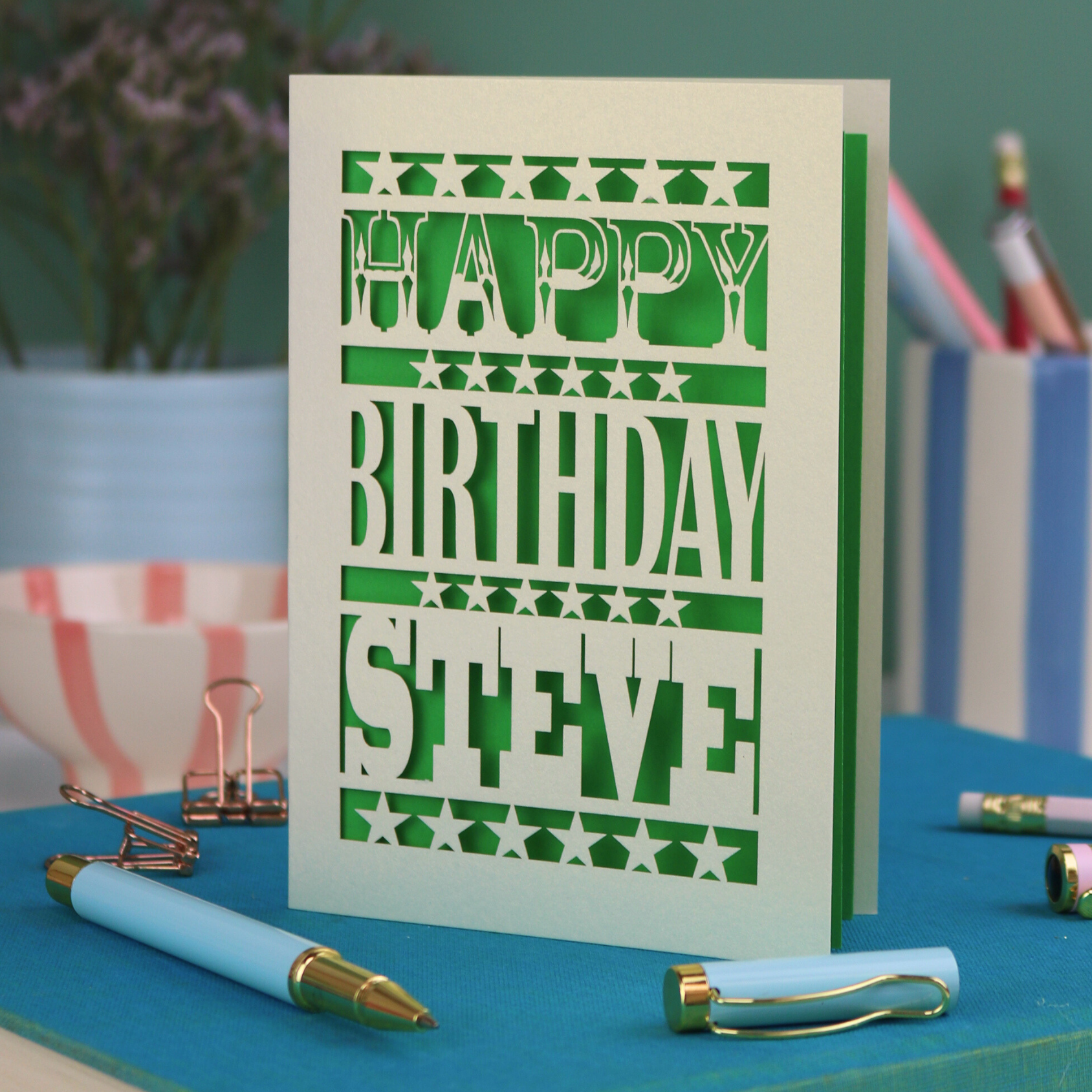 A laser cut personalised birthday card that says "Happy Birthday Steve" in bold text with star design.