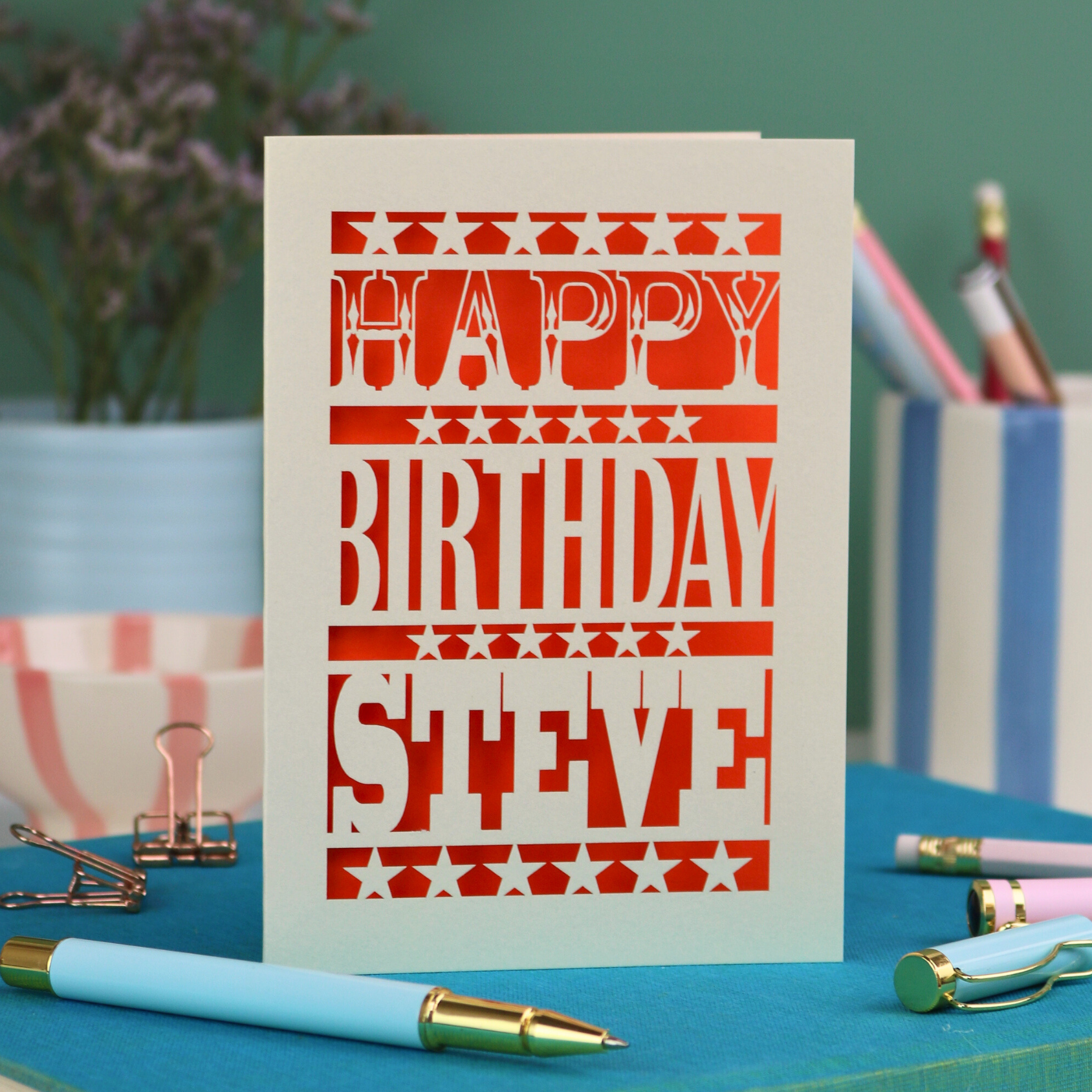 A laser cut personalised birthday card that says "Happy Birthday Steve" in bold text with star design.