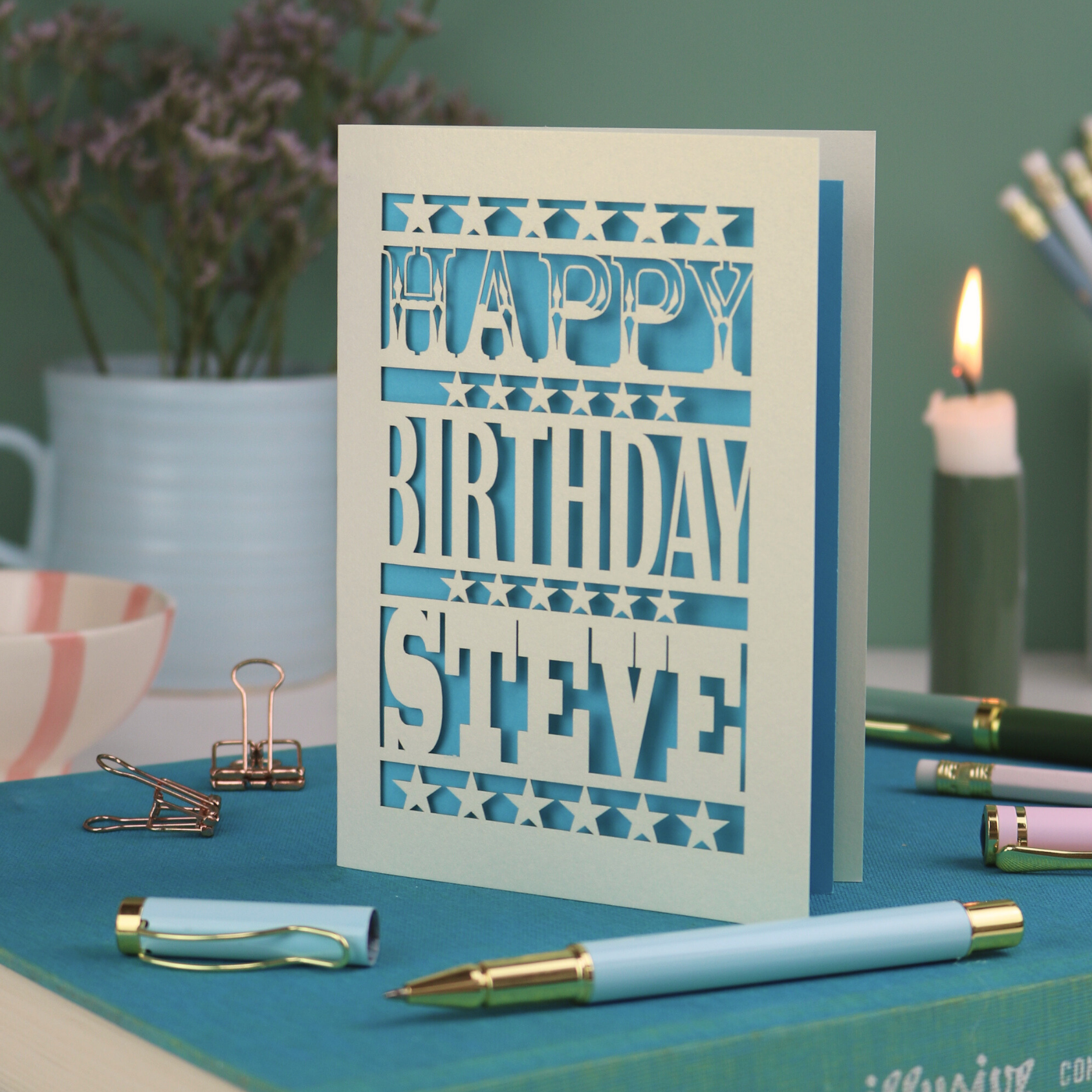 A laser cut personalised birthday card that says "Happy Birthday Steve" in bold text with star design.