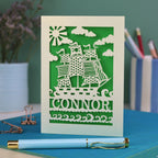 A personalised laser cut boys' birthday card with cut out pirate ship illustration and the name Alfie 