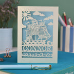 A personalised laser cut kids birthday card with cut out pirate ship illustration and the name Alfie 