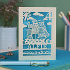 A personalised laser cut birthday card with cut out pirate ship illustration, the number 4 in the top right corner and the name Alfie 