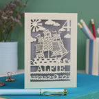 A personalised laser cut birthday card with cut out pirate ship illustration, the number 4 in the top right corner and the name Alfie 