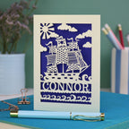 A personalised laser cut birthday card with cut out pirate ship illustration and the name Alfie 