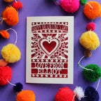 A personalised paper cut Valentine's card with a cut out heart surrounded by flowers.
