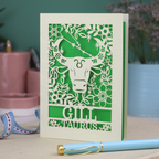 Personalised laser cut Birthday card with zodiac design featuring a bull on a pink background, with a pen and decorative ribbon in the foreground.