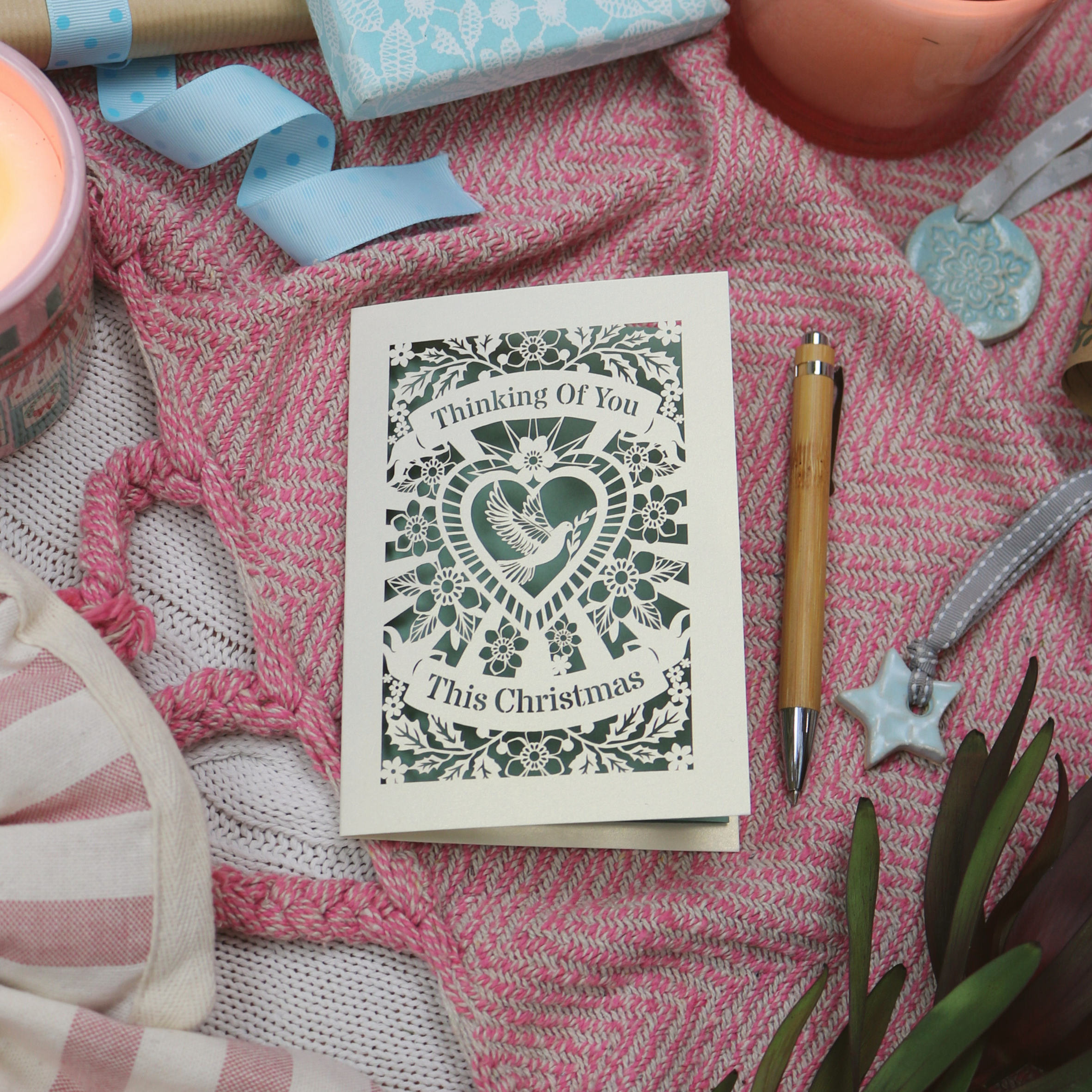 A Christmas card for someone grieving, laser cut with dove design and the words "Thinking of you This Christmas"