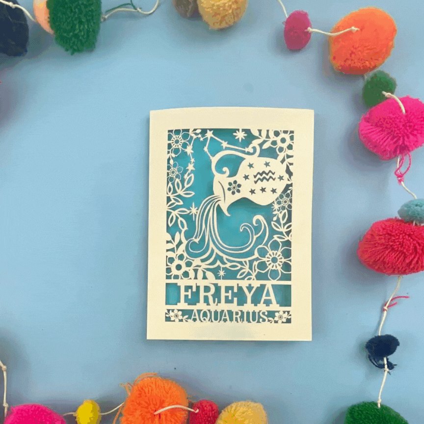 Decorative Aquarius Birthday card opening and closing, with 'FREYA AQUARIUS' design on a blue background with colourful pom-poms.