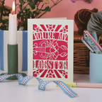 Valentines Card with lobster illustration and text on a decorative stand with candles and flowers in the background