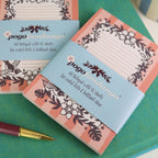 Small notebooks with floral designs and 'pogofandango' branding on a green surface.