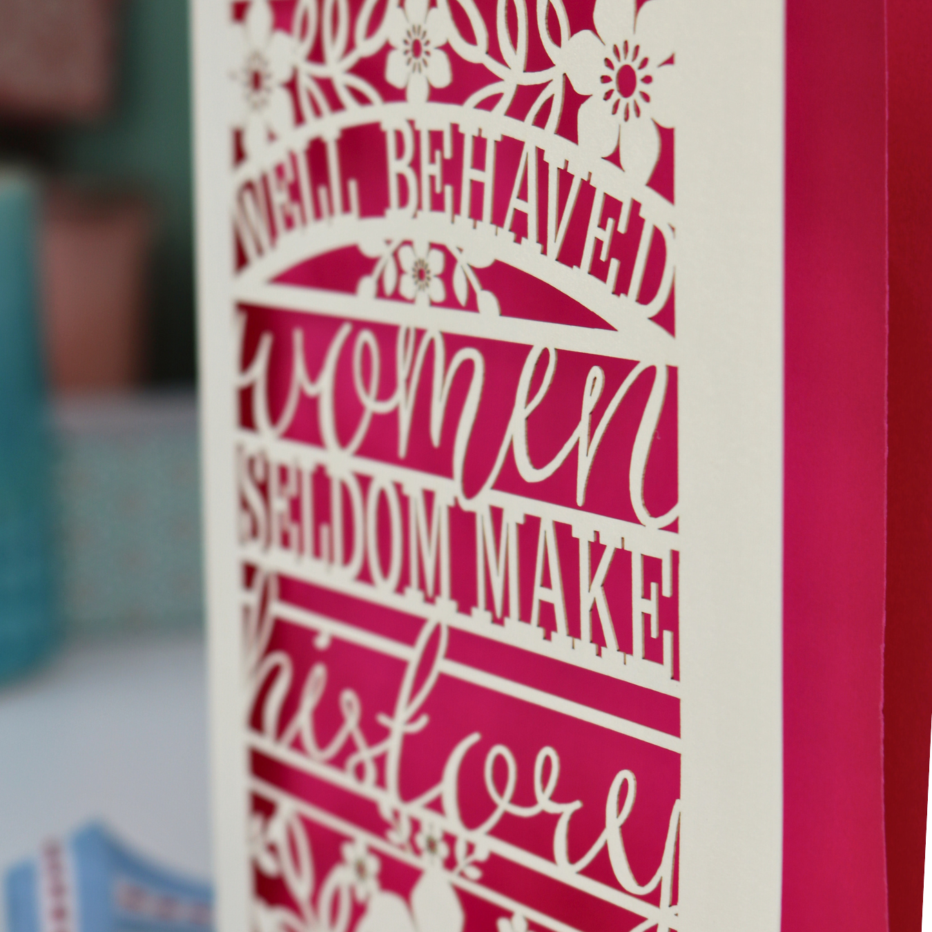 Decorative laser cut International Women's Day card with text 'Well Behaved Women Seldom Make History'.