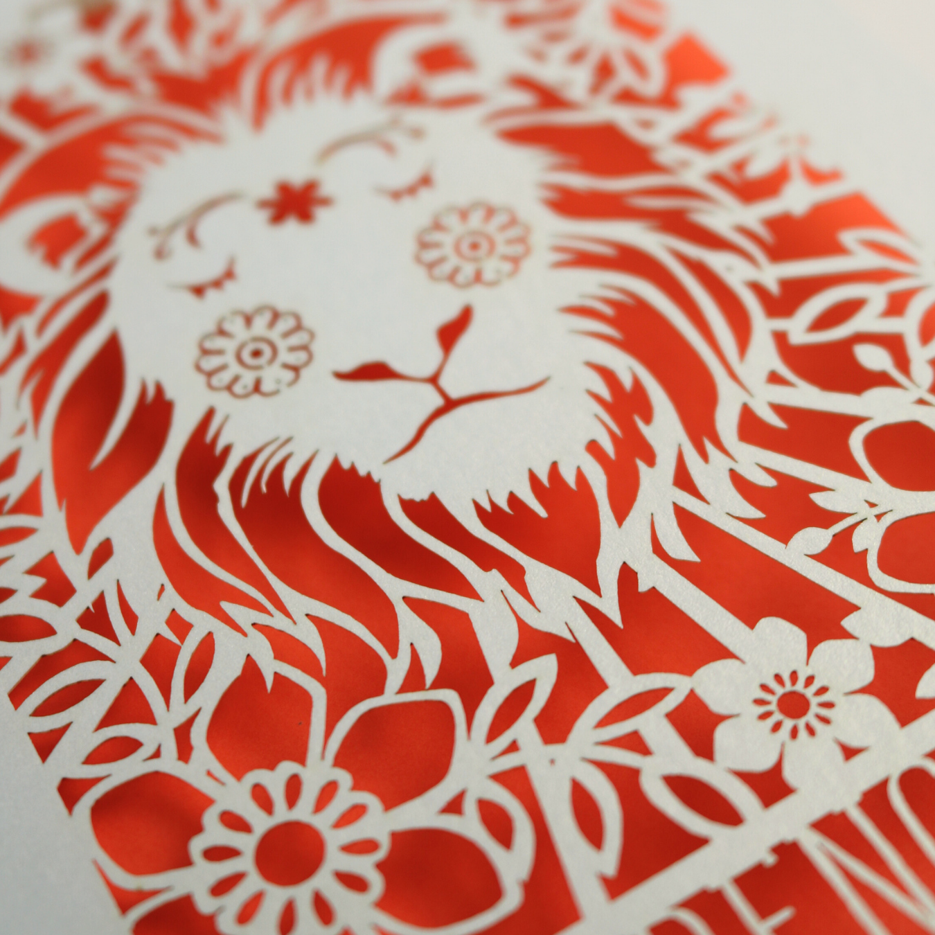 A laser cut greetings card based on the Strength tarot card, with cut out lion design and the word "Strength" 