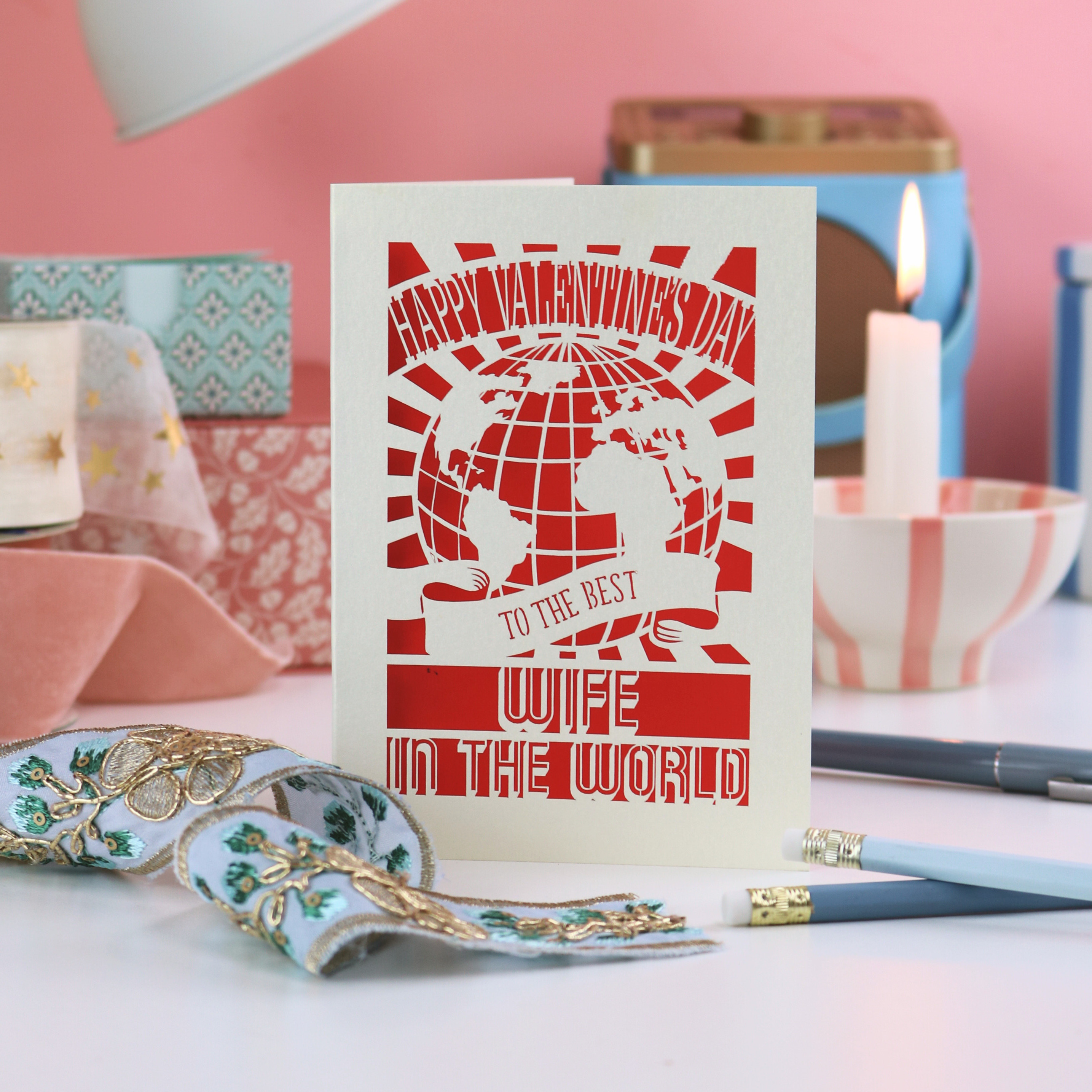 Laser cut Valentine's card for the best wife in the world on a decorative table with candles and décor items.