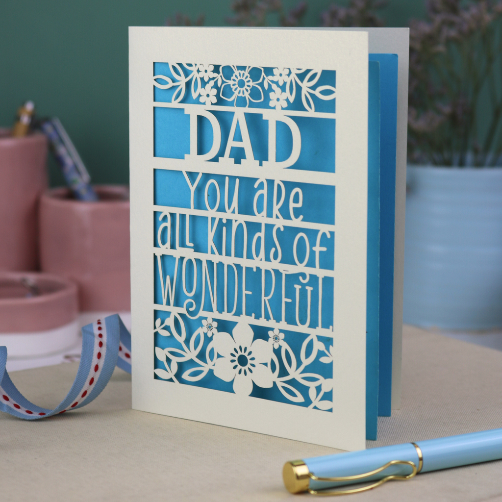 A laser cut cream Father's Day card, personalised with a name at the top, in this case, "Dad", and the text, "You are all kinds of wonderful"