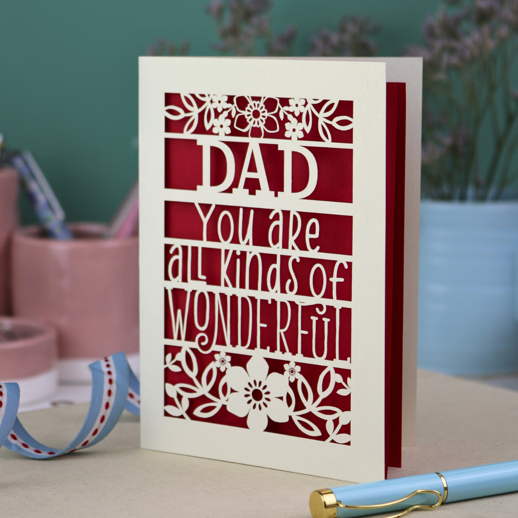 A laser cut cream Father's Day card, personalised with a name at the top, in this case, "Dad", and the text, "You are all kinds of wonderful"