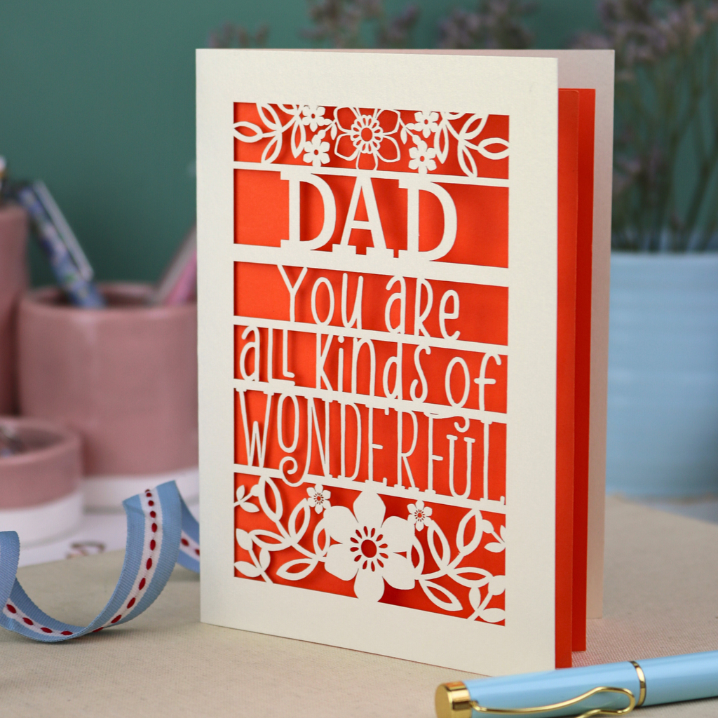 A laser cut cream Father's Day card, personalised with a name at the top, in this case, "Dad", and the text, "You are all kinds of wonderful"