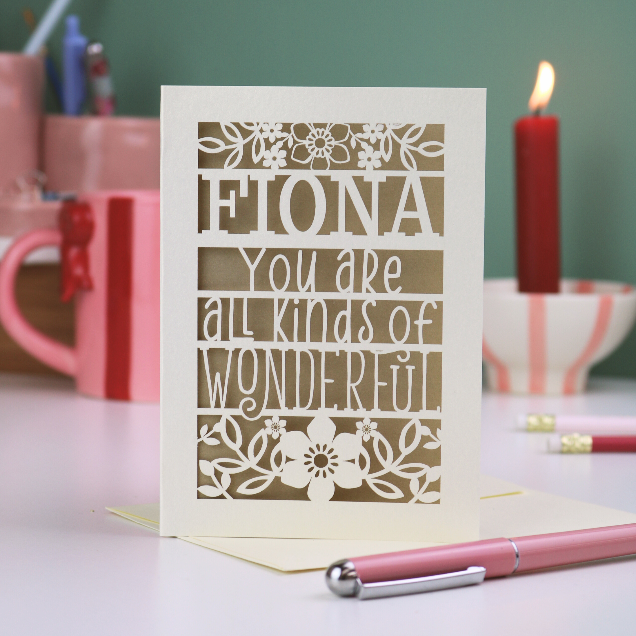 Laser cut personalised Card with personalized message, Fiona, you are all kinds of wonderful, on a desk with stationery items