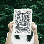 A charcoal print for kitchens with the words "adventure awaits"