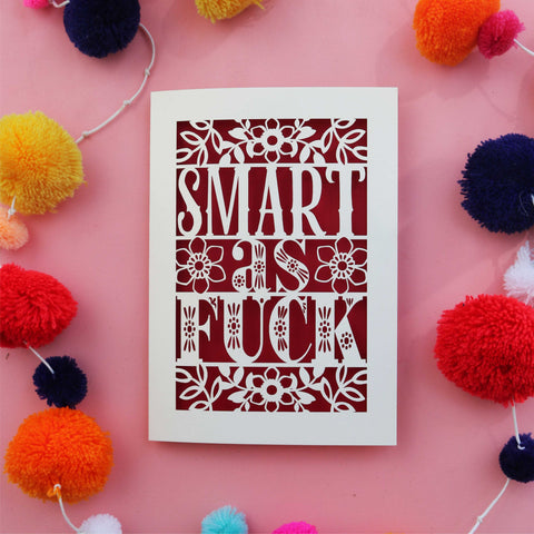 A laser cut graduation card that says "Smart as fuck"