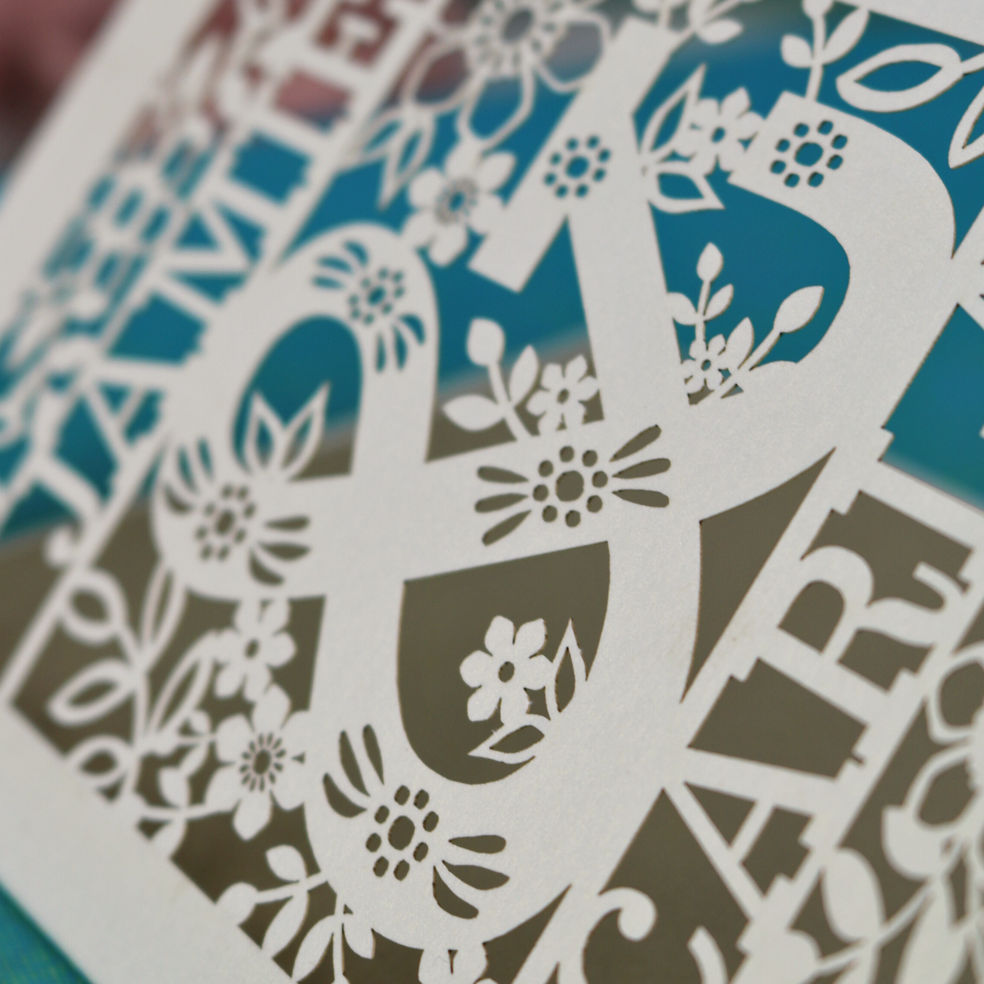 Decorative paper cutout with floral patterns on a blue background