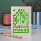 A personalised cut out 18th birthday card, personalised with a name, and the text "18, Happy Birthday"