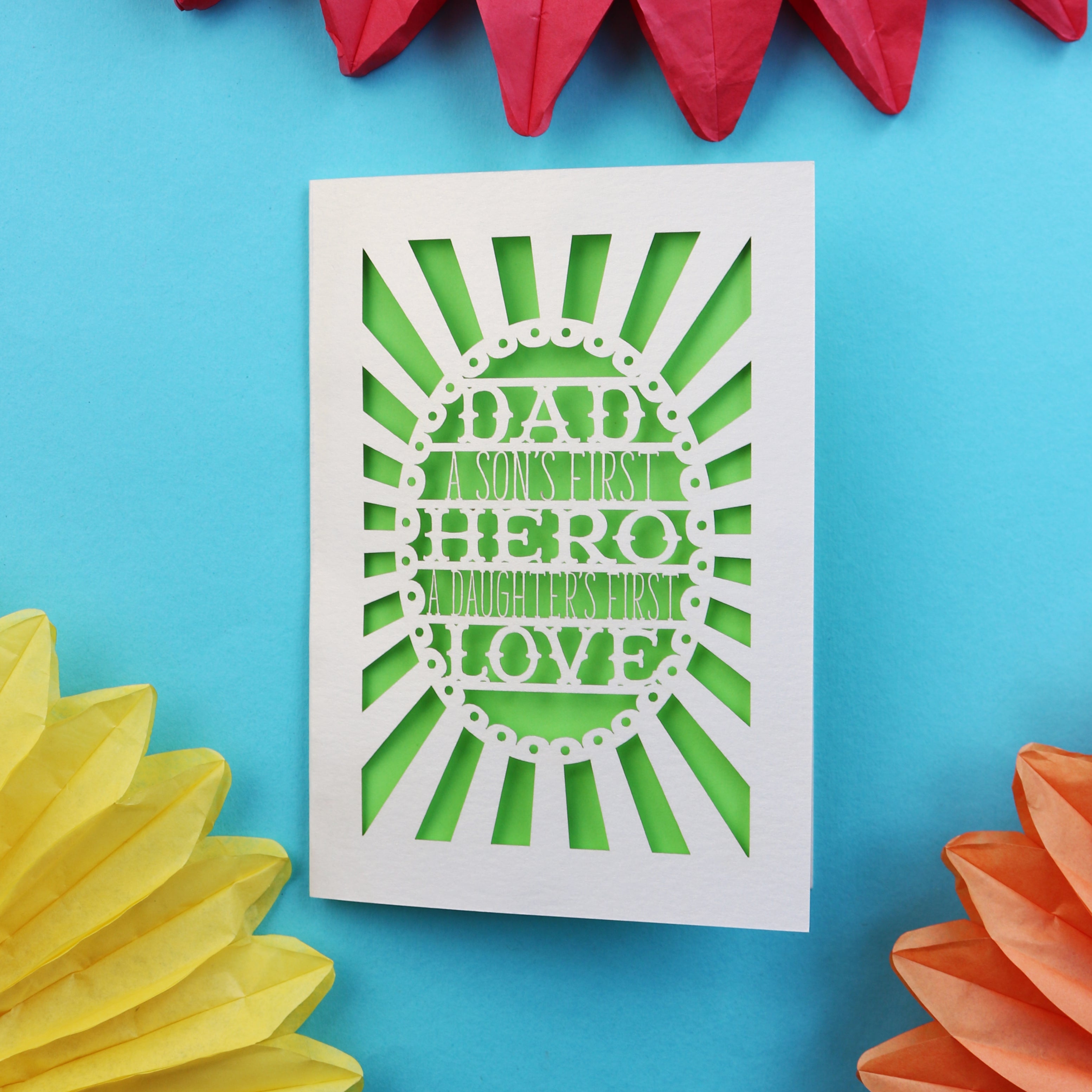 A laser cut father's day card that says "Dad, A son's first hero, a daughter's first love"