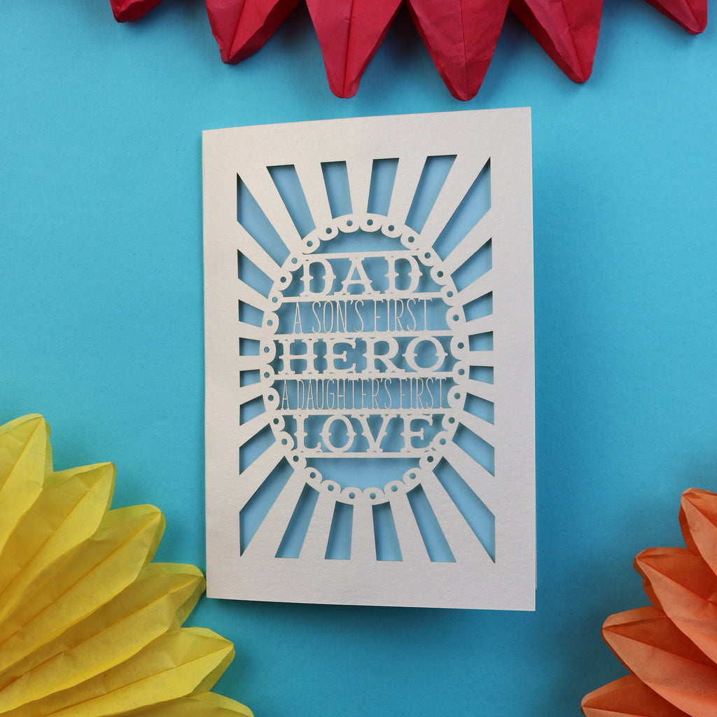A papercut father's day card that says "Dad, A son's first hero, a daughter's first love"