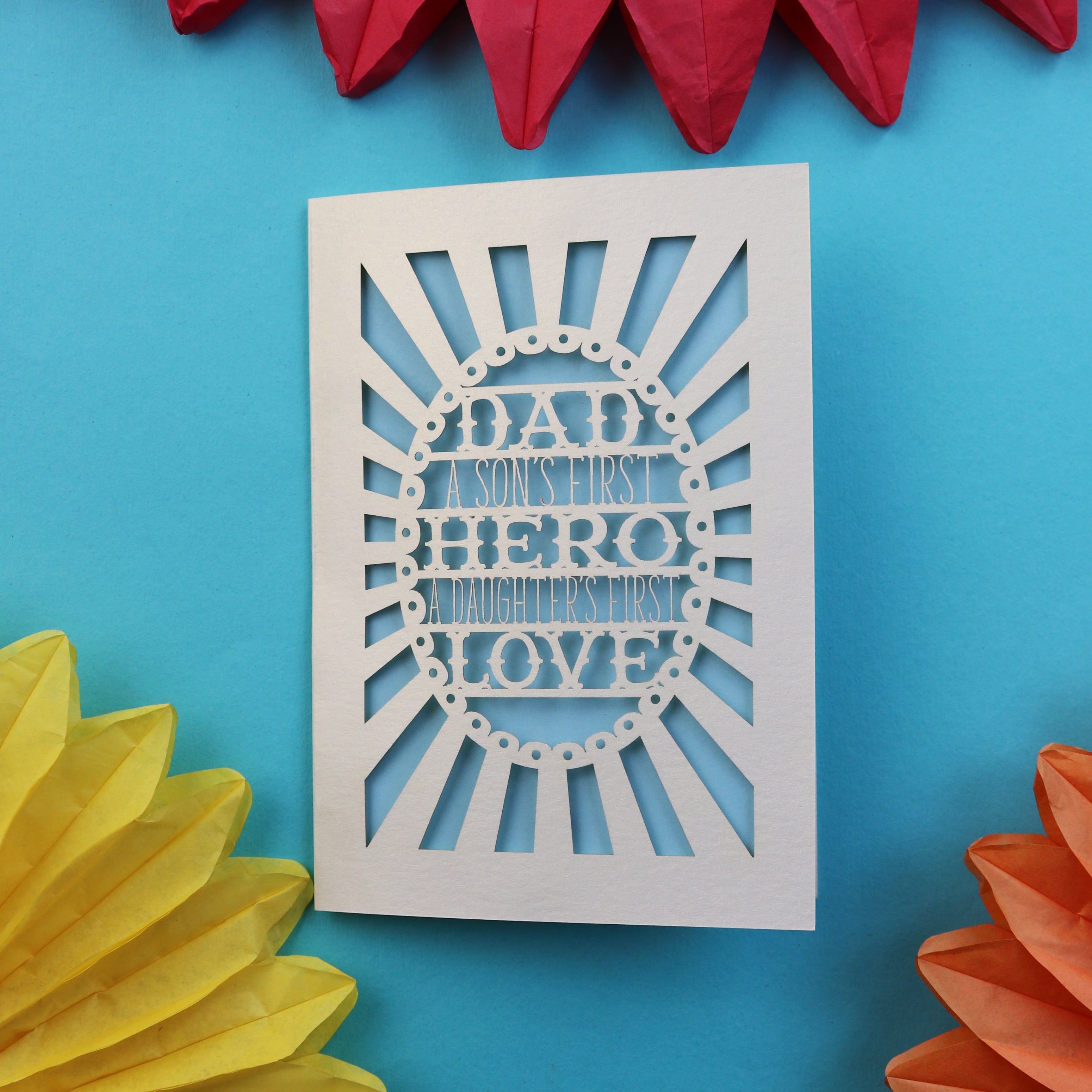 A papercut father's day card that says "Dad, A son's first hero, a daughter's first love"