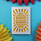 A sweet cut out father's day card that says "Dad, A son's first hero, a daughter's first love"
