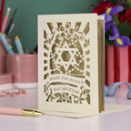 Bat Mitzvah card with Star of David design on a desk with stationery items.