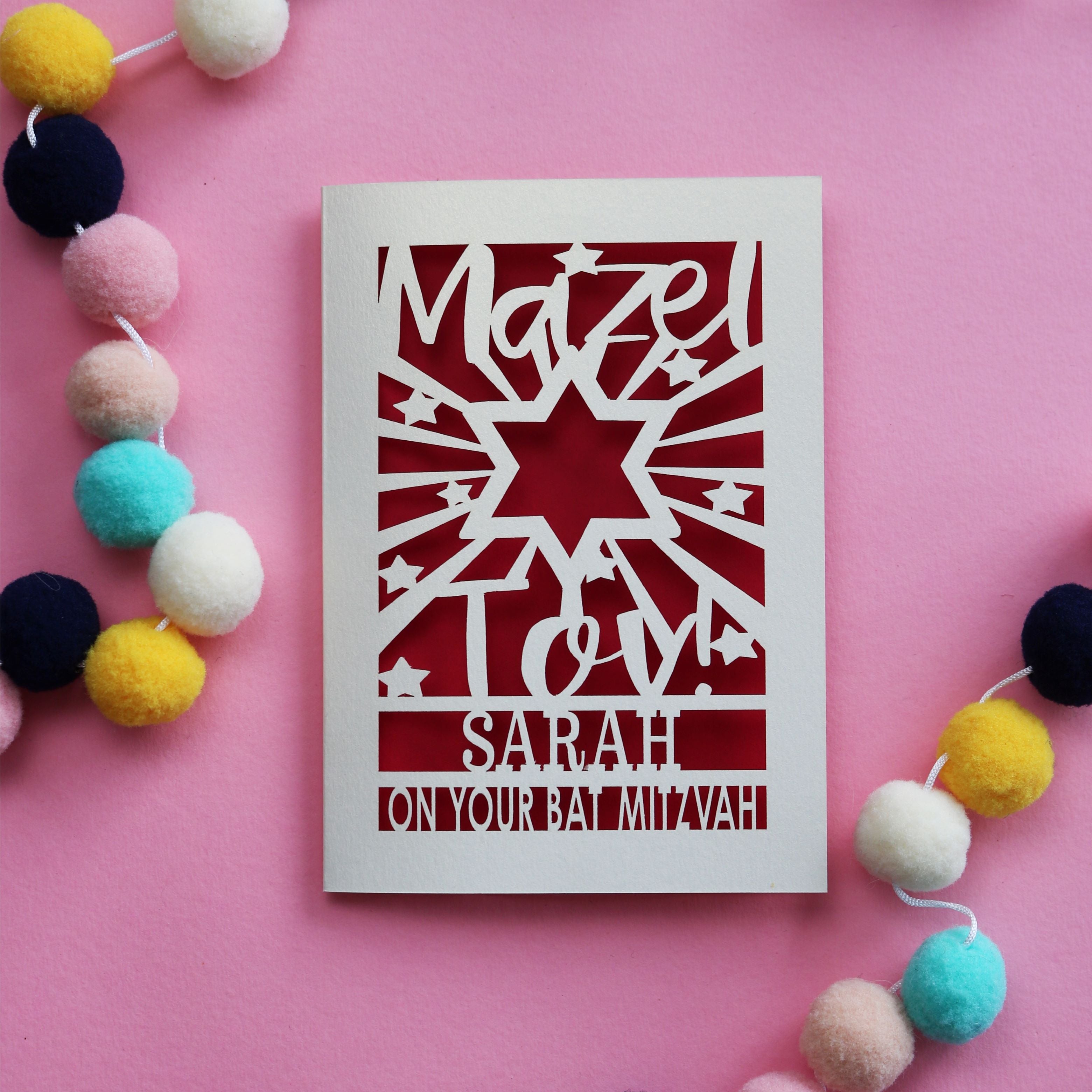 A laser cut personalised Bat Mitzvah card that says Mazel Tov! 