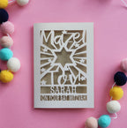 A cut out personalised Bat Mitzvah card that says Mazel Tov, Name, on your Bat Mitzvah 