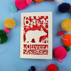 Birthday Card with bear design and 'Oliver' text on a blue background with colourful pom-poms.
