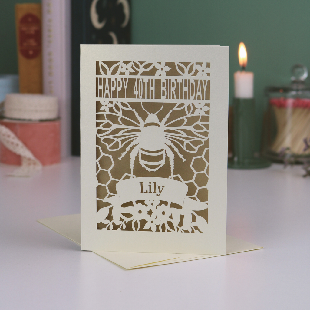 Laser-cut birthday card with bee design and 'Happy 40th Birthday' text on a white surface.