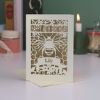 Laser-cut birthday card with bee design and 'Happy 40th Birthday' text on a white surface.