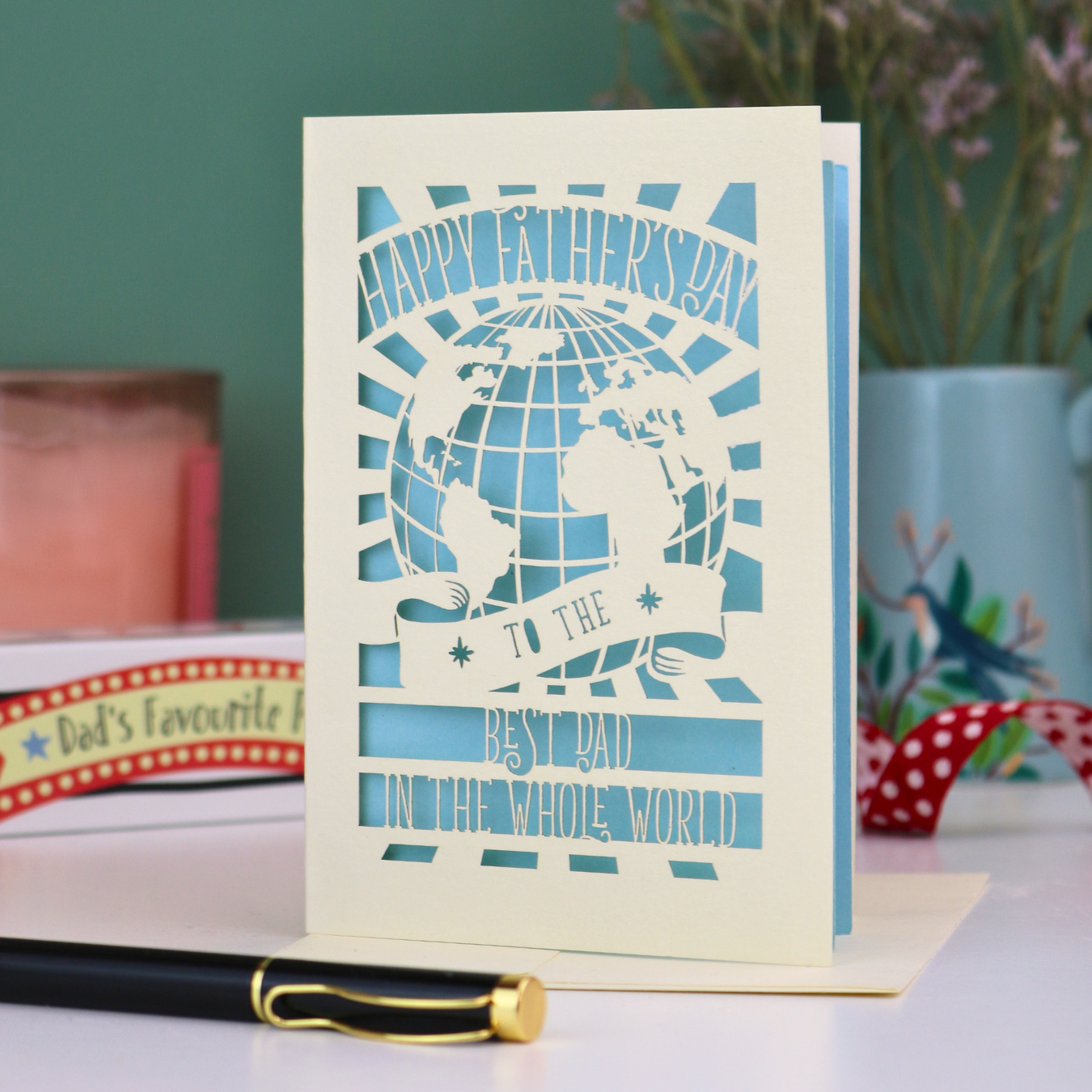 A laser cut Father's Day card with globe design and the text "Happy Father's Day to the Best Dad In the Whole world"