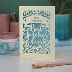 A cream laser cut card with floral design and the text "Mrs Newton. Best Teacher Ever!" 