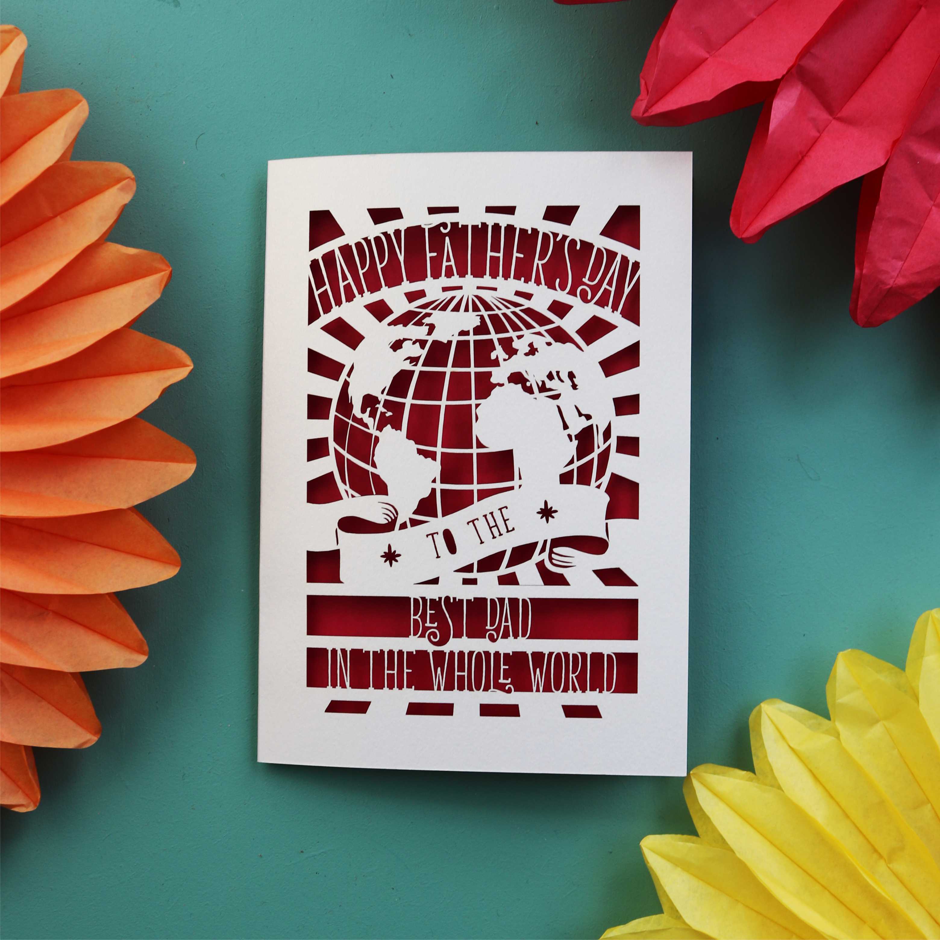 Father's Day cards with a cut out of the world and the words "Happy Fathers Day to the best dad in the whole world"