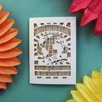 A special Father's Day card with a cut out of the world and the words "Happy Fathers Day to the best dad in the whole world"