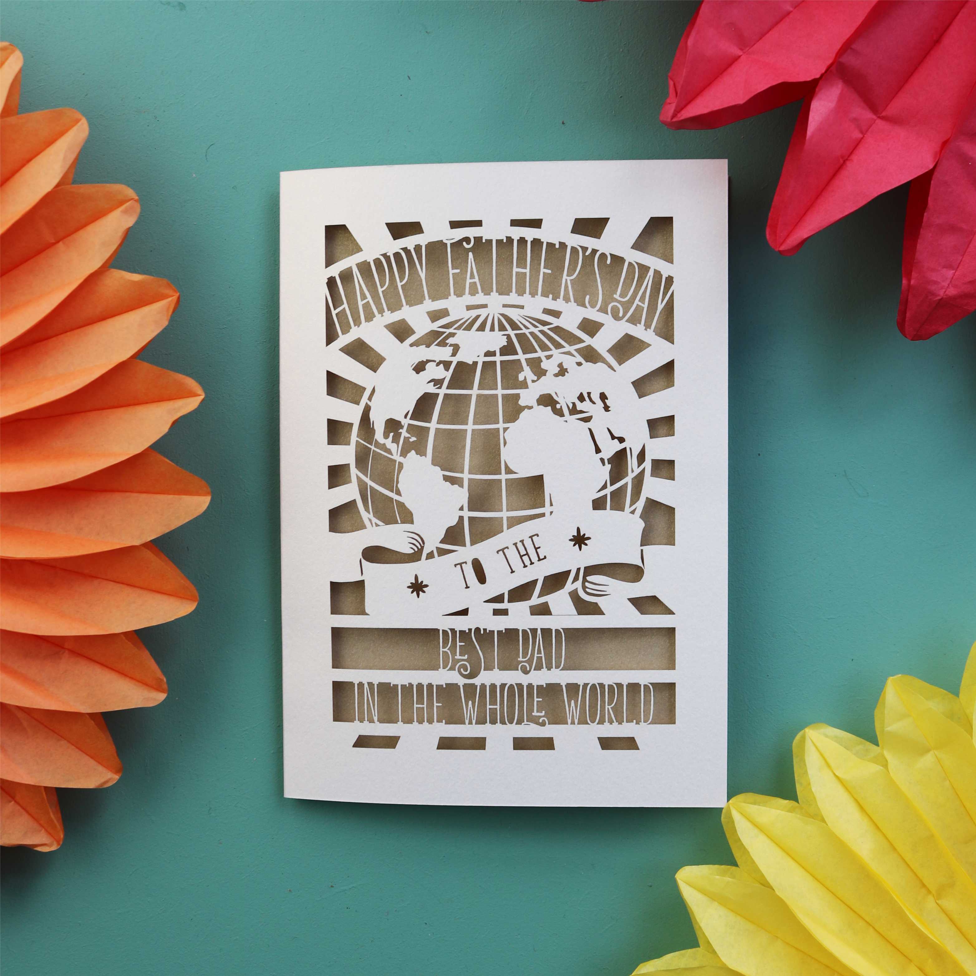 A special Father's Day card with a cut out of the world and the words "Happy Fathers Day to the best dad in the whole world"