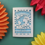 A unique Father's Day card with a cut out of the world and the words "Happy Fathers Day to the best dad in the whole world"