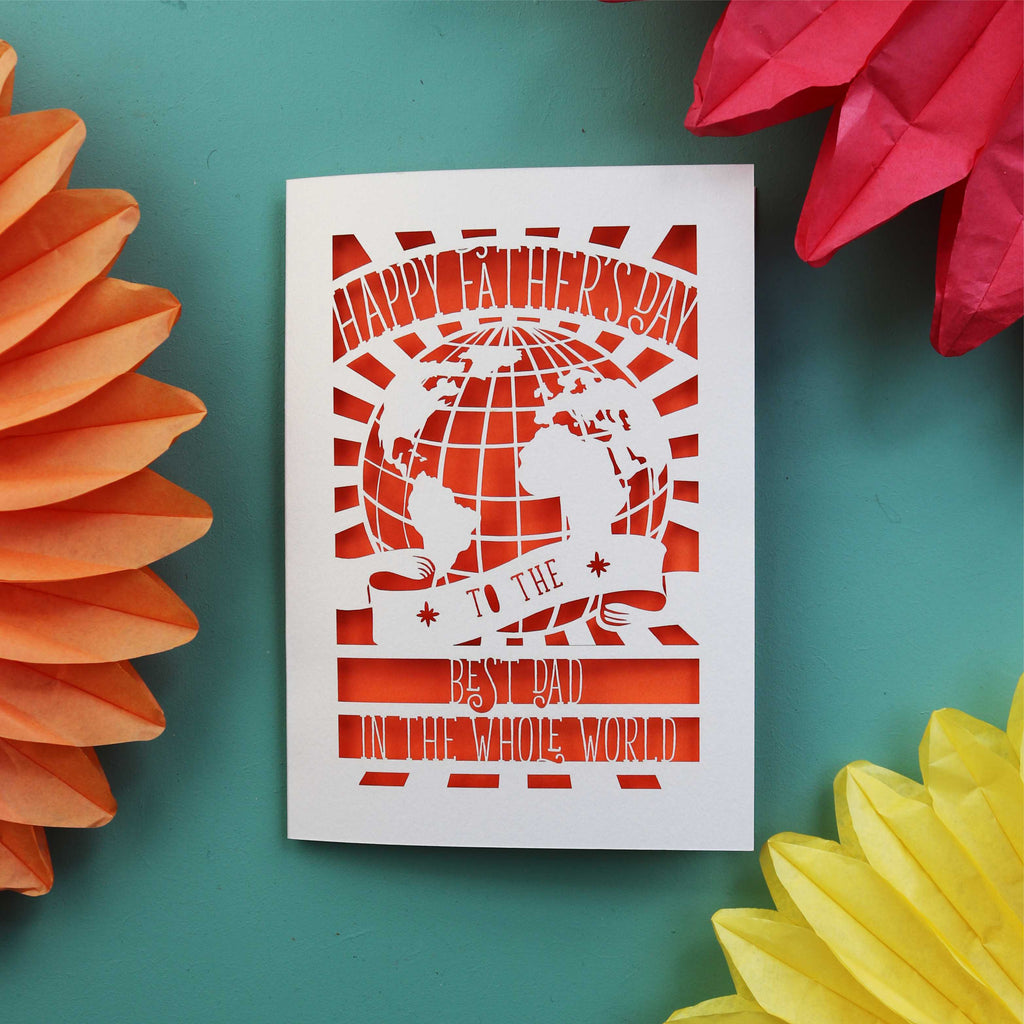 A unusual Father's Day card made in the UK with a cut out of the world and the words "Happy Fathers Day to the best dad in the whole world"
